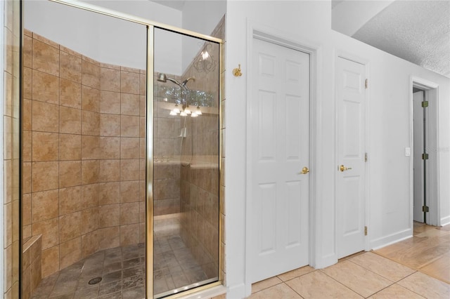 1803 Glenbay Ct, Windermere, FL 34786 - full bathroom with tile patterned flooring, a textured ceiling, baseboards, and a stall shower