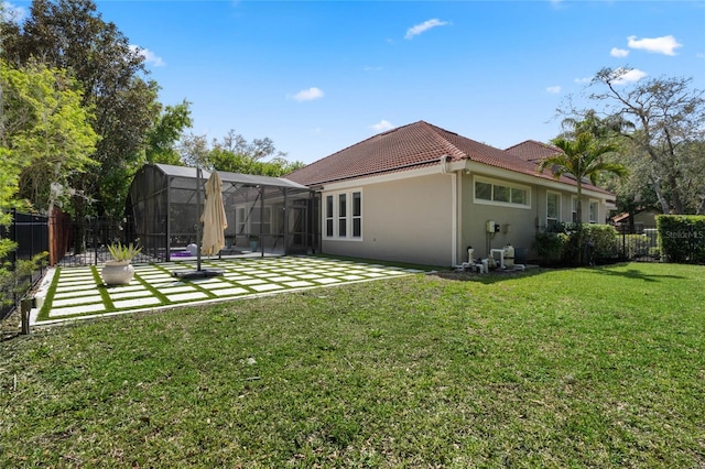 1803 Glenbay Ct, Windermere, FL 34786 - rear view of property with a tiled roof, a lawn, a patio area, a fenced backyard, and stucco siding