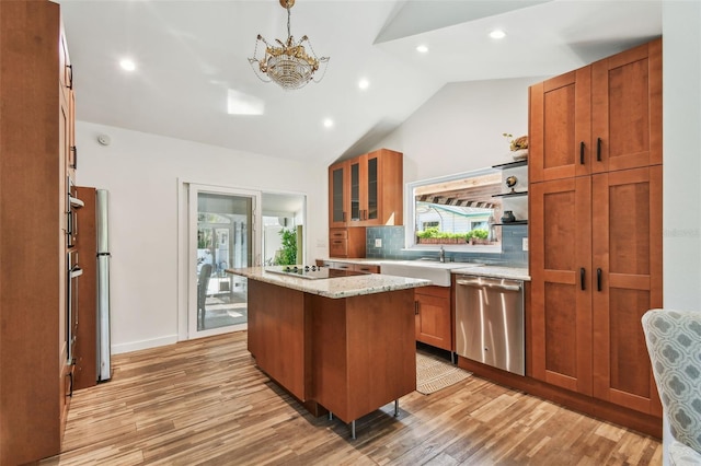 913 Tennessee Ln, Sarasota, FL 34234 - kitchen featuring stainless steel dishwasher, a sink, light wood finished floors, a center island, and healthy amount of natural light