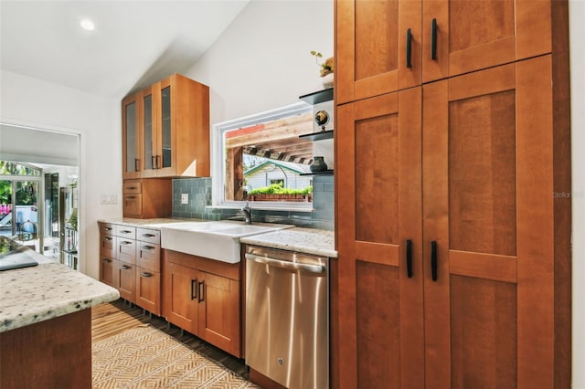 913 Tennessee Ln, Sarasota, FL 34234 - kitchen with dishwasher, decorative backsplash, a sink, glass insert cabinets, and vaulted ceiling