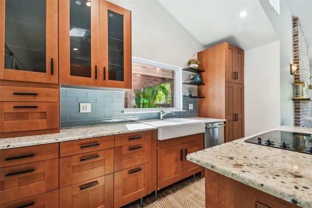 913 Tennessee Ln, Sarasota, FL 34234 - kitchen with a sink, lofted ceiling, tasteful backsplash, brown cabinetry, and light stone countertops