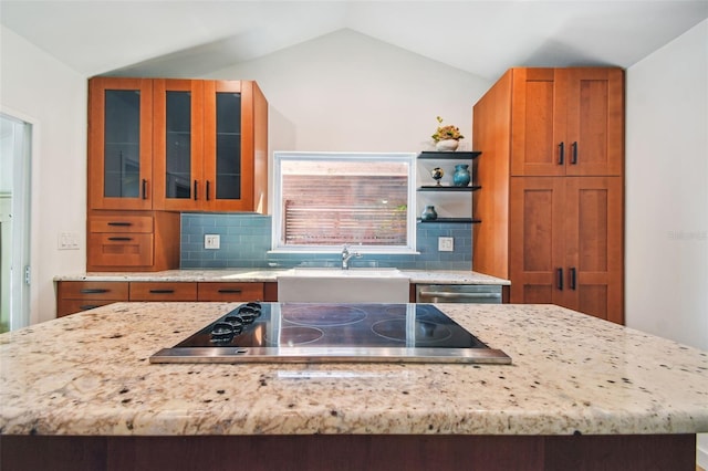 913 Tennessee Ln, Sarasota, FL 34234 - kitchen featuring black electric stovetop, brown cabinetry, vaulted ceiling, decorative backsplash, and stainless steel dishwasher