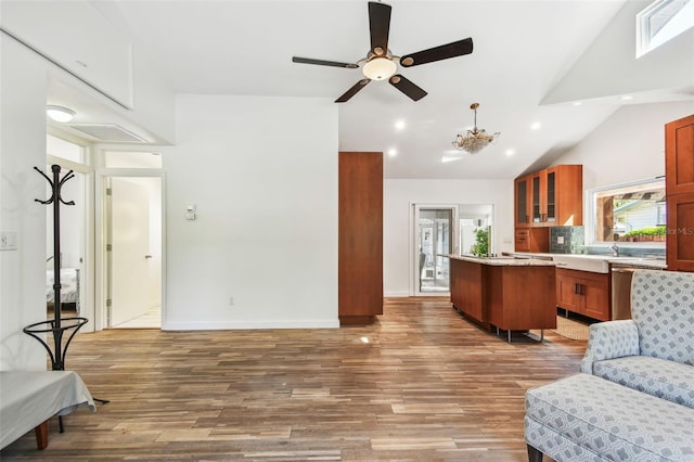 913 Tennessee Ln, Sarasota, FL 34234 - kitchen with open floor plan, a center island, glass insert cabinets, lofted ceiling, and light countertops