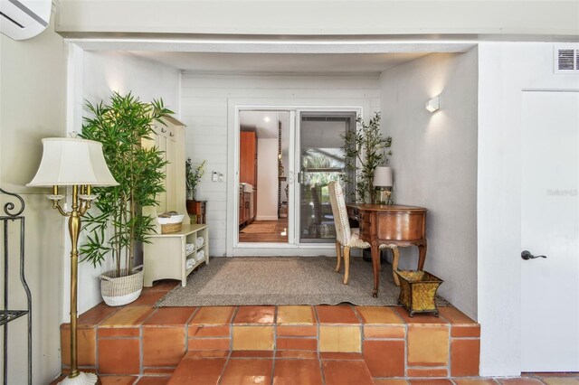 913 Tennessee Ln, Sarasota, FL 34234 - foyer with a wall unit AC and tile patterned floors