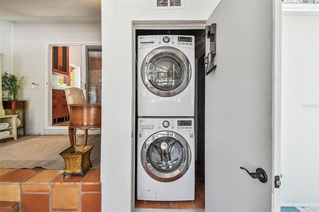 913 Tennessee Ln, Sarasota, FL 34234 - laundry room with stacked washer / dryer and healthy amount of natural light