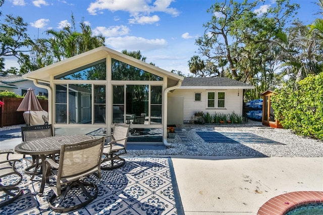 913 Tennessee Ln, Sarasota, FL 34234 - rear view of house with a sunroom, a patio area, and outdoor dining area
