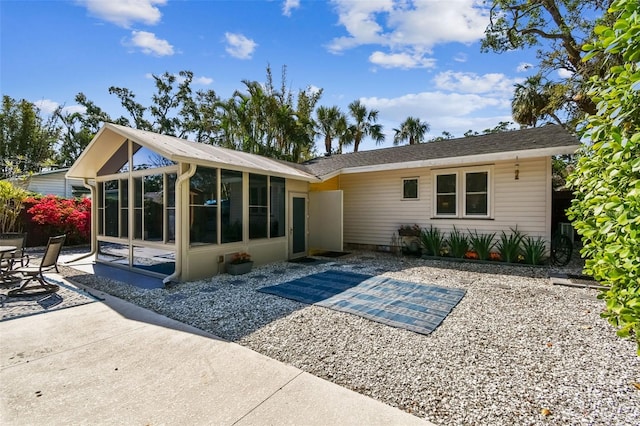 913 Tennessee Ln, Sarasota, FL 34234 - rear view of house featuring a sunroom and a patio area