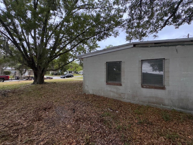 view of home's exterior with concrete block siding