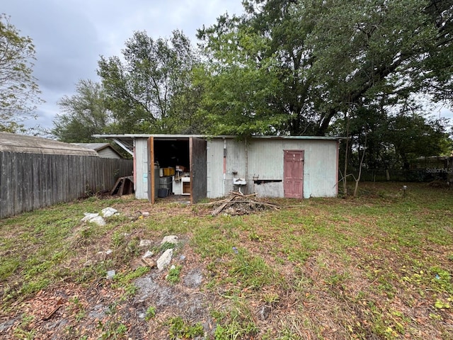 view of outdoor structure with fence and an outdoor structure