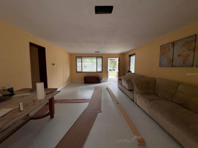 carpeted living room with baseboards