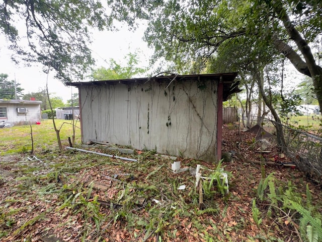 view of shed featuring fence