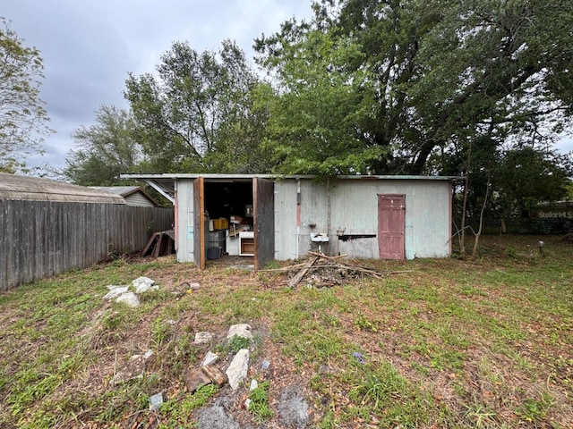 view of outdoor structure with fence and an outdoor structure