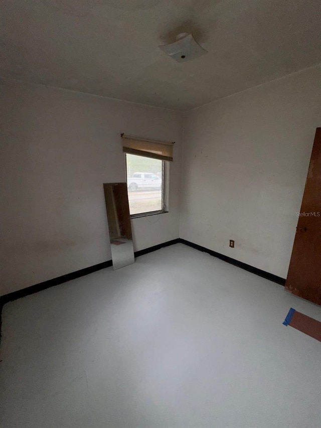 spare room featuring baseboards