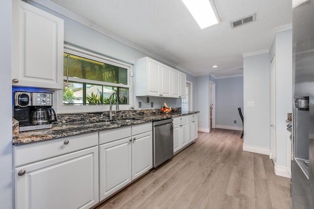 kitchen featuring baseboards, crown molding, white cabinets, visible vents, and dishwasher