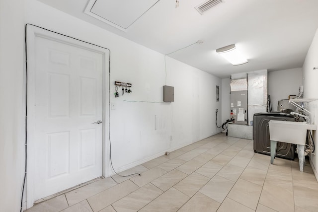 laundry area with visible vents, laundry area, and heating unit