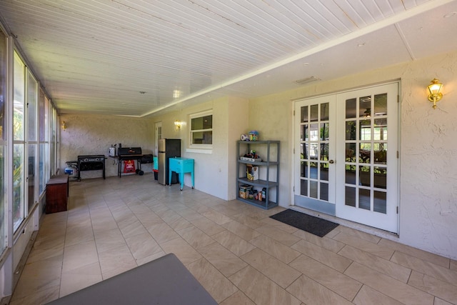 sunroom featuring a wealth of natural light and french doors