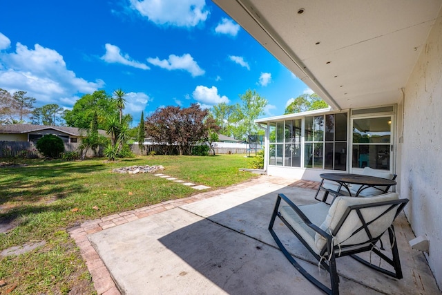 view of patio featuring a fenced backyard and a sunroom