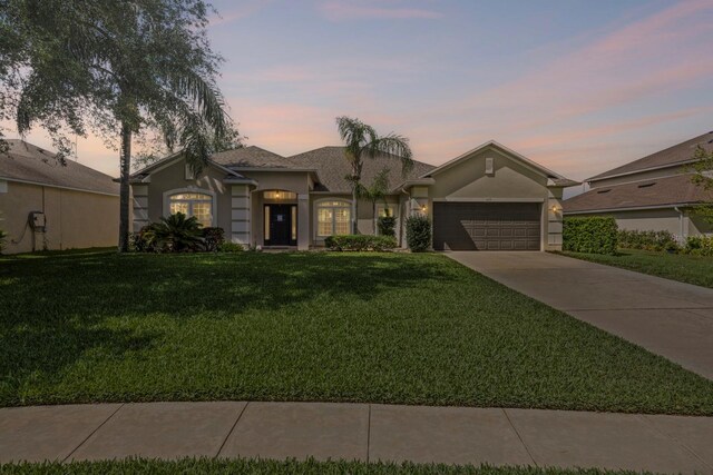 235 Largovista Dr, Oakland, FL 34787 - ranch-style home with a yard, an attached garage, concrete driveway, and stucco siding