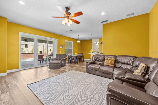 235 Largovista Dr, Oakland, FL 34787 - living room with visible vents, baseboards, a ceiling fan, and wood finished floors