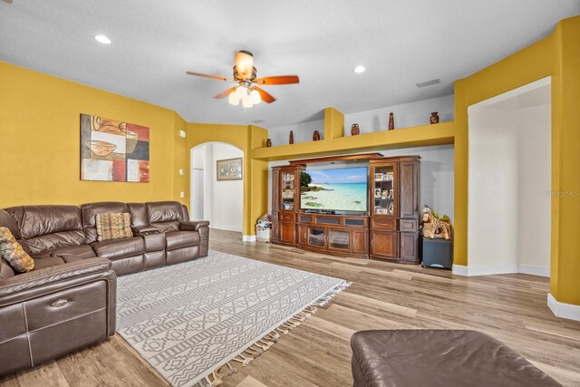 235 Largovista Dr, Oakland, FL 34787 - living area with baseboards, arched walkways, ceiling fan, light wood-style floors, and recessed lighting