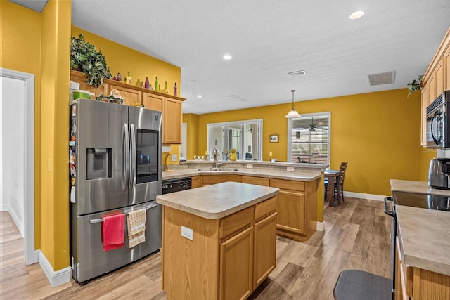 235 Largovista Dr, Oakland, FL 34787 - kitchen featuring a peninsula, light countertops, visible vents, stainless steel appliances, and a sink