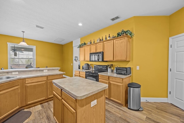 235 Largovista Dr, Oakland, FL 34787 - kitchen featuring a sink, visible vents, light wood-style flooring, and black appliances