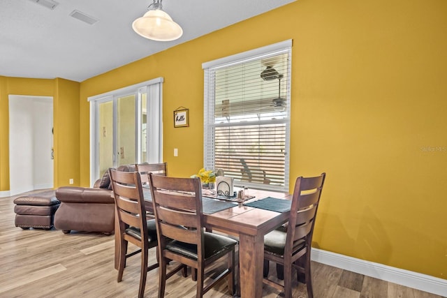 235 Largovista Dr, Oakland, FL 34787 - dining room with light wood finished floors, baseboards, and visible vents