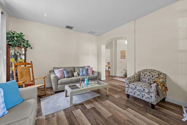 235 Largovista Dr, Oakland, FL 34787 - living area featuring visible vents, baseboards, arched walkways, and wood finished floors