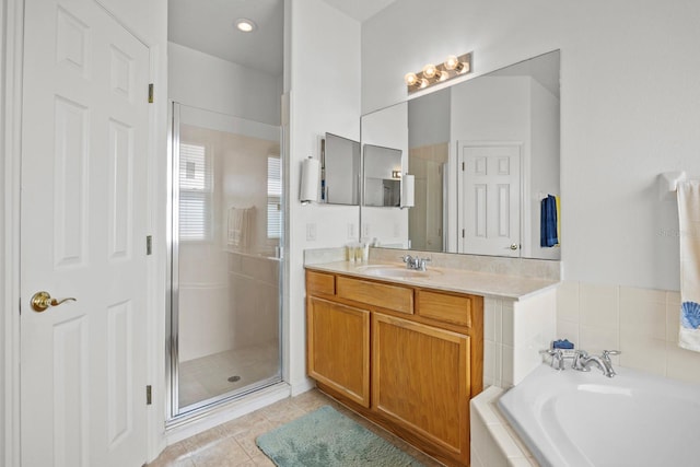 235 Largovista Dr, Oakland, FL 34787 - full bathroom featuring a bath, a shower stall, tile patterned flooring, and vanity