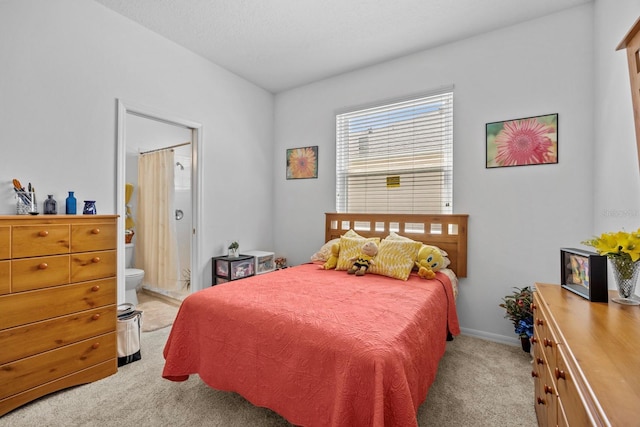 235 Largovista Dr, Oakland, FL 34787 - bedroom featuring ensuite bathroom, baseboards, and light colored carpet