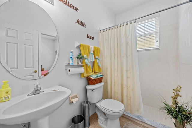 235 Largovista Dr, Oakland, FL 34787 - bathroom featuring tile patterned floors, tiled shower, a sink, and toilet