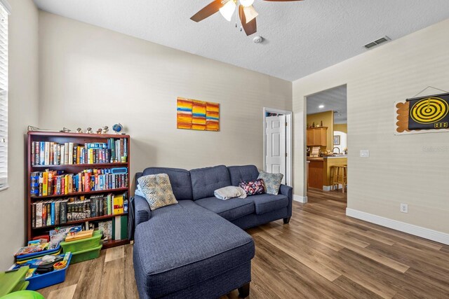 235 Largovista Dr, Oakland, FL 34787 - living room featuring wood finished floors, baseboards, a ceiling fan, and visible vents