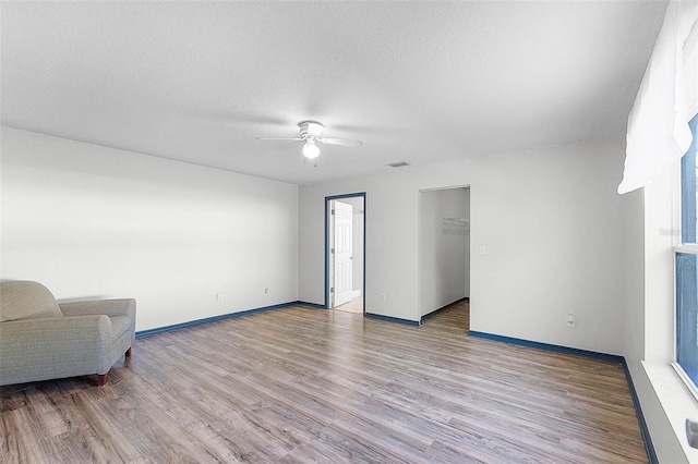 37 Lindsay Dr, Palm Coast, FL 32137 - living area with visible vents, baseboards, a ceiling fan, and wood finished floors
