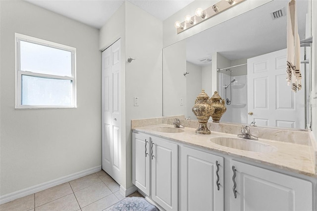 37 Lindsay Dr, Palm Coast, FL 32137 - bathroom featuring baseboards, a sink, tile patterned flooring, and visible vents