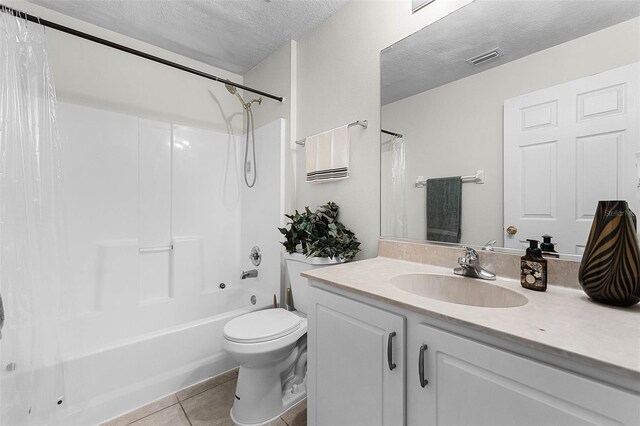 37 Lindsay Dr, Palm Coast, FL 32137 - bathroom featuring visible vents, a textured ceiling, shower / bath combo with shower curtain, vanity, and tile patterned flooring