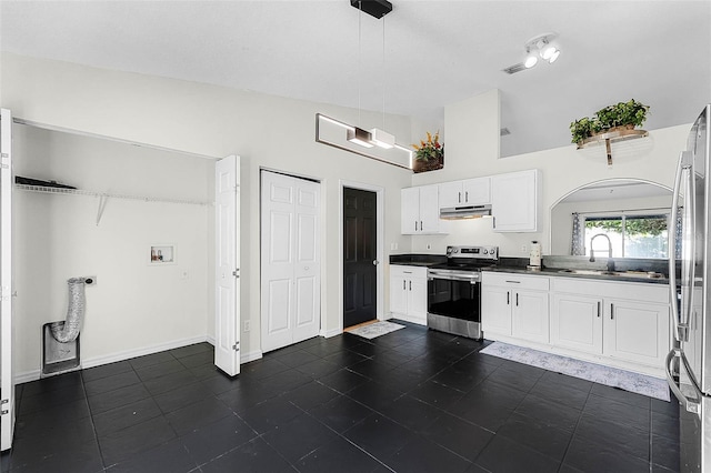 37 Lindsay Dr, Palm Coast, FL 32137 - kitchen featuring vaulted ceiling, dark countertops, white cabinets, stainless steel appliances, and pendant lighting
