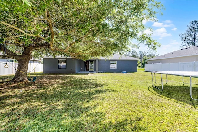 37 Lindsay Dr, Palm Coast, FL 32137 - view of yard with a trampoline and fence