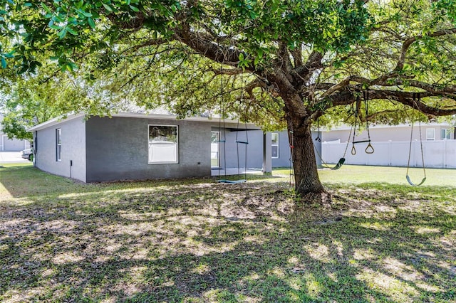 37 Lindsay Dr, Palm Coast, FL 32137 - exterior space featuring a front yard, fence, and stucco siding