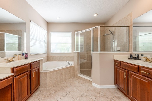 bathroom with a sink, tile patterned flooring, a bath, and a stall shower