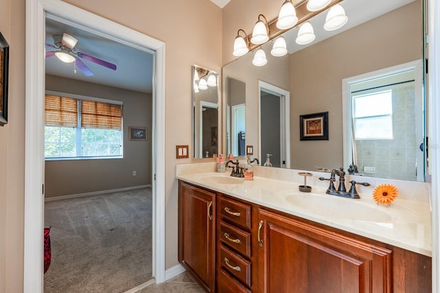 bathroom with a healthy amount of sunlight, a sink, and a ceiling fan