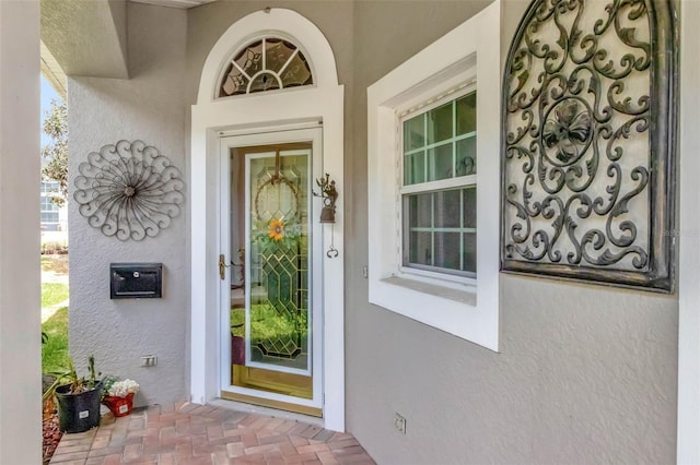 property entrance with stucco siding