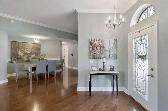 entrance foyer with crown molding, baseboards, an inviting chandelier, and wood finished floors