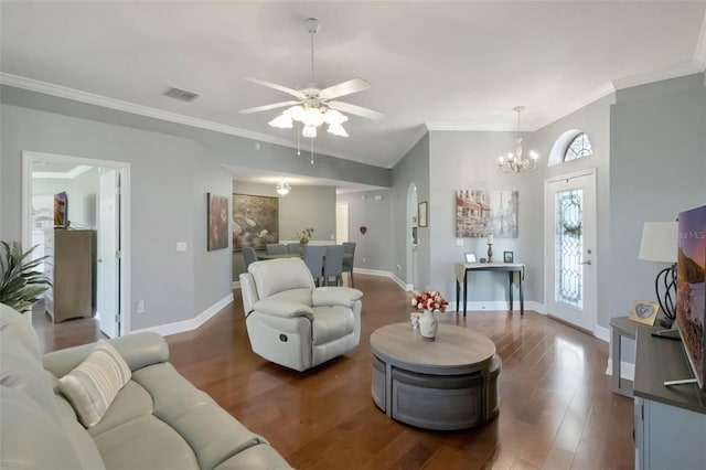 living area with crown molding, ceiling fan with notable chandelier, visible vents, wood finished floors, and baseboards