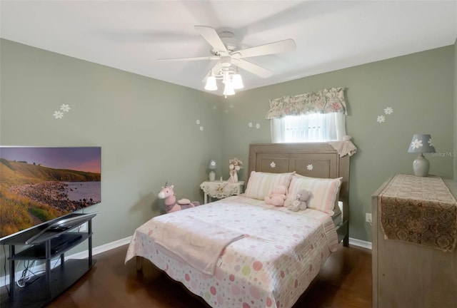 bedroom with baseboards, a ceiling fan, and wood finished floors