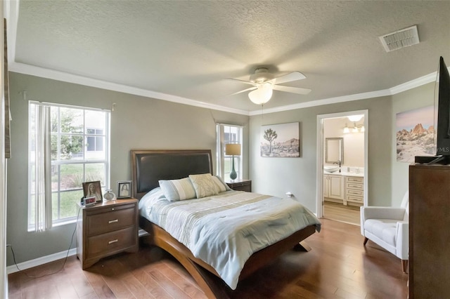 bedroom with a textured ceiling, multiple windows, and visible vents