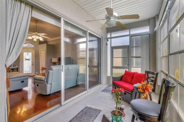 sunroom featuring a ceiling fan