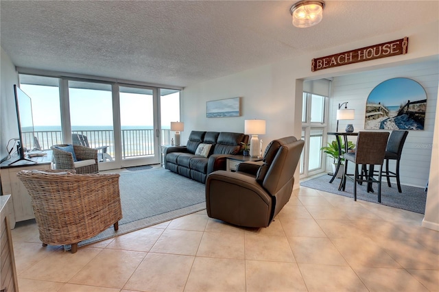 5203 S Atlantic Ave Unit 416B, New Smyrna Beach, FL 32169 - living area with a textured ceiling and light tile patterned floors