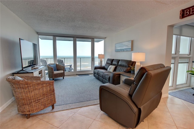 5203 S Atlantic Ave Unit 416B, New Smyrna Beach, FL 32169 - living room featuring light tile patterned flooring and a textured ceiling