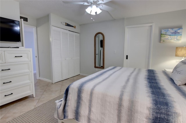 5203 S Atlantic Ave Unit 416B, New Smyrna Beach, FL 32169 - bedroom with light tile patterned floors, a ceiling fan, and baseboards