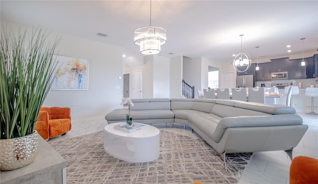 living room with visible vents, recessed lighting, a notable chandelier, and stairs